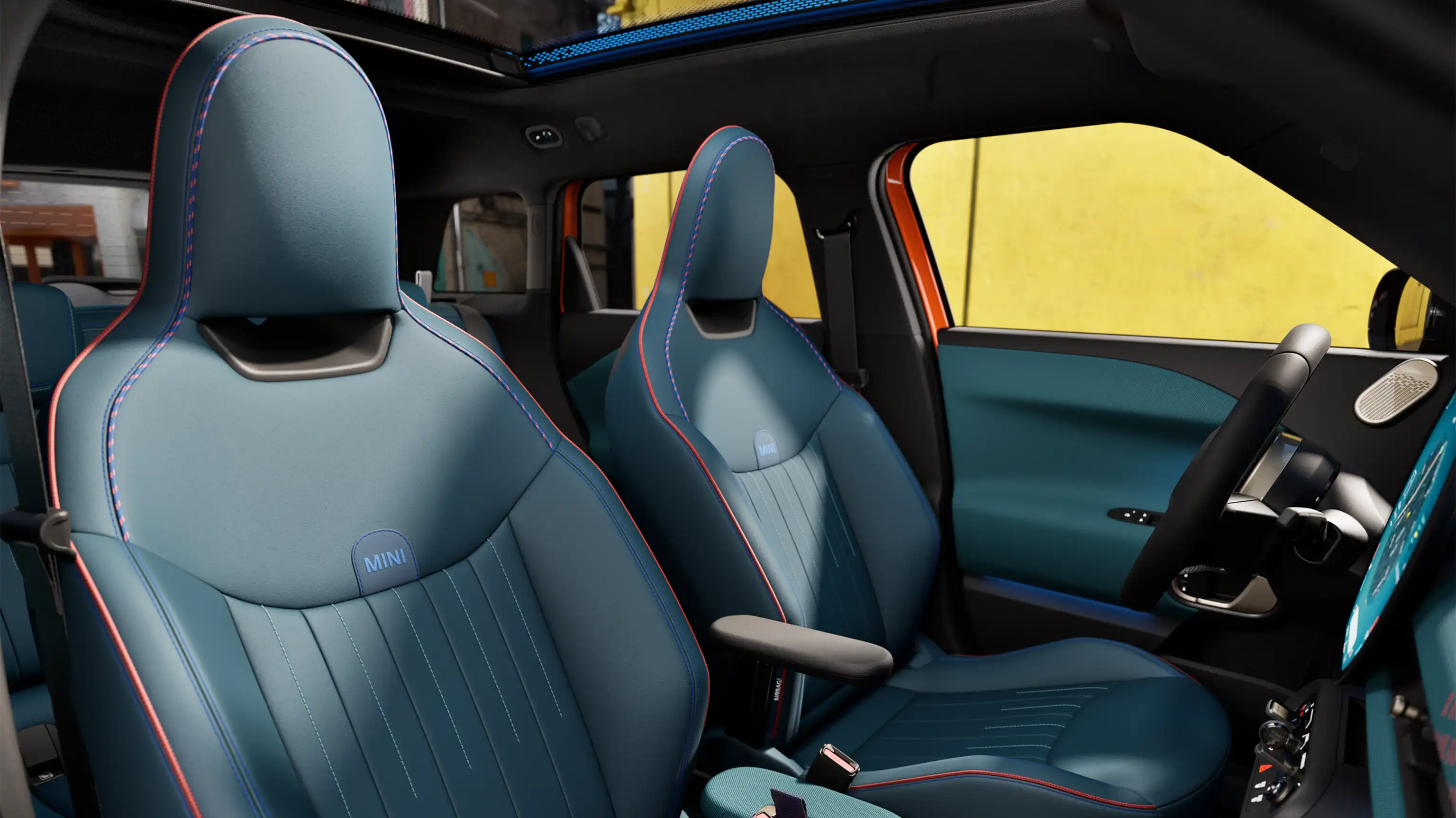 Interior perspective of the all-electric MINI Aceman is showing the dashboard, steering wheel, round display, panorama glassroof and back of the frontseats