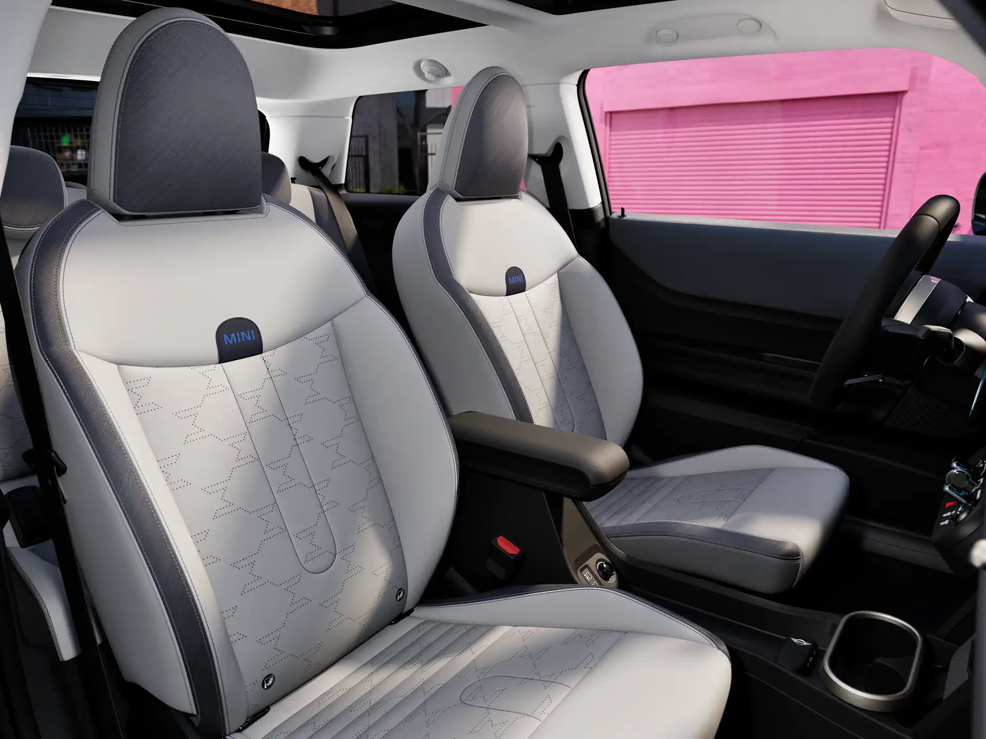 Interior perspective of the MINI Cooper is showing the dashboard, steering wheel, round display, panorama glassroof and back of the frontseats.