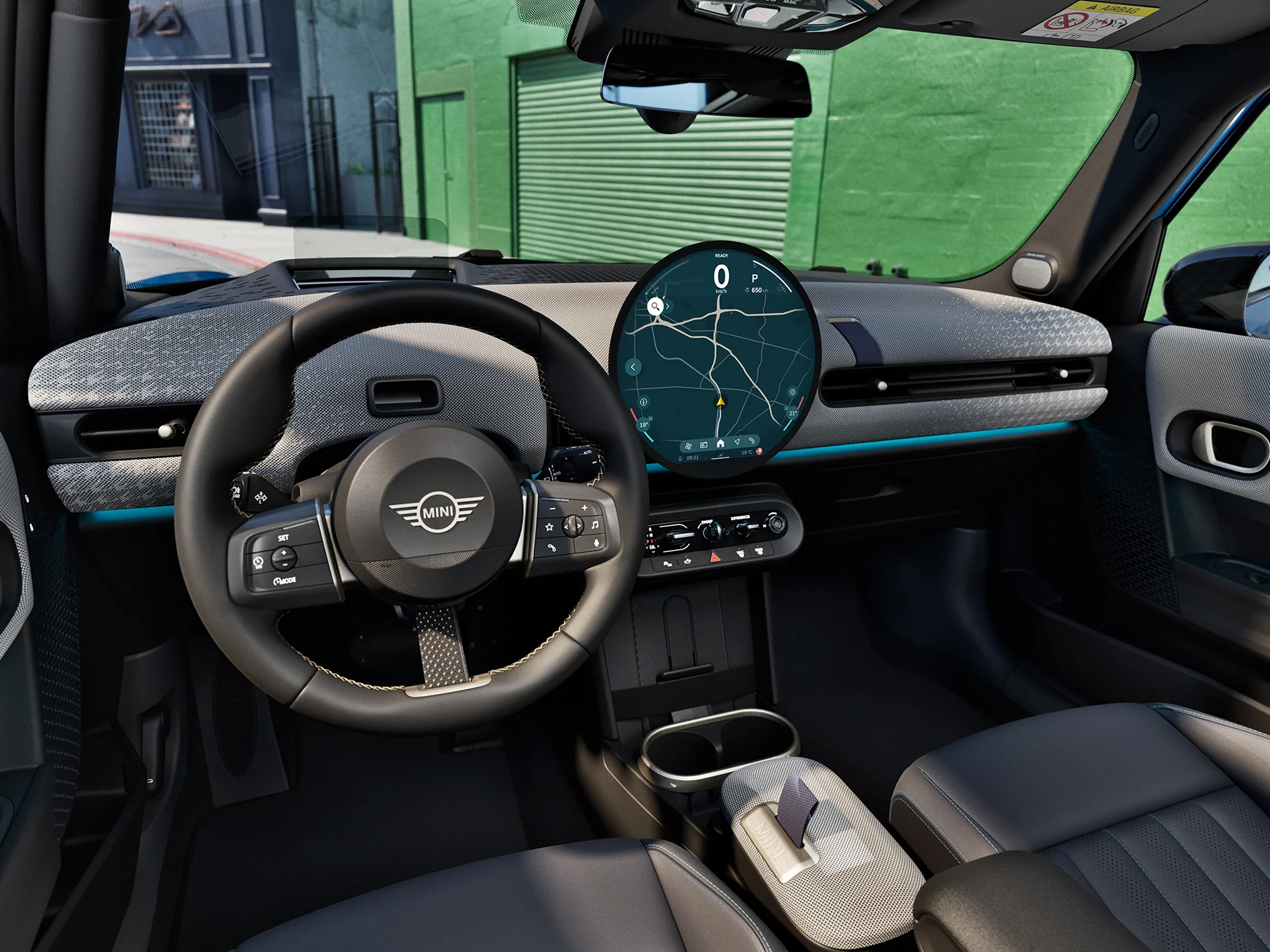 Interior view of the MINI Cooper 5-Door with focus on the steering wheel, the dashboard and the interaction unit.