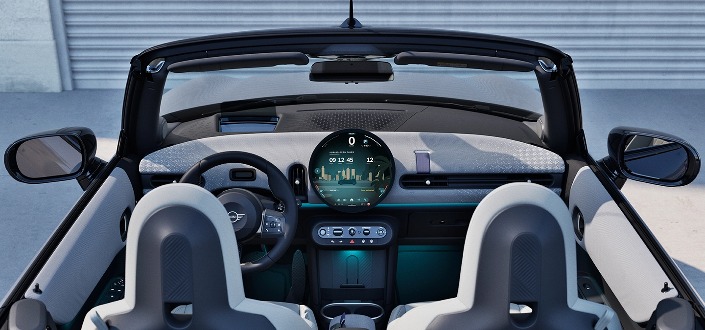 Rear view of the MINI Cooper Convertible interior with focus on the dashboard and the interaction unit.