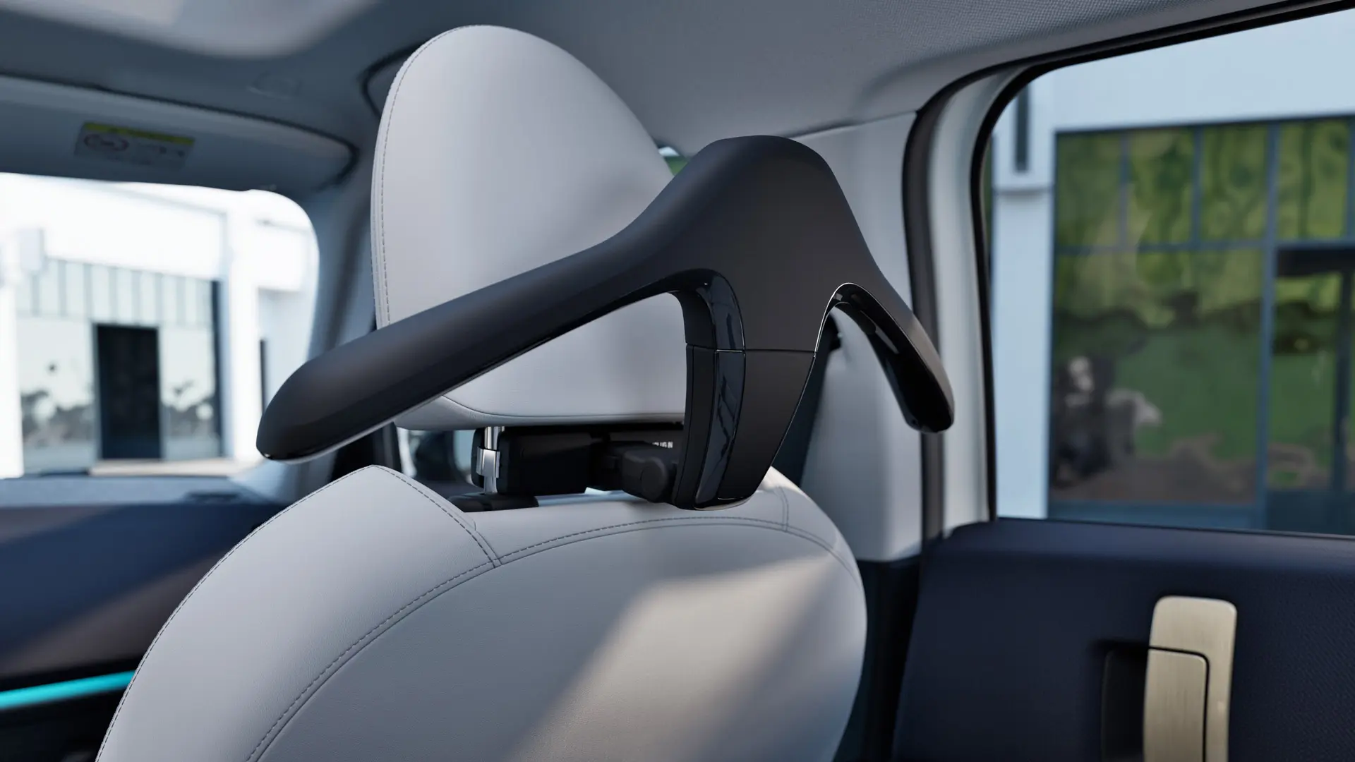 MINI Travel & Comfort System clothes hanger installed on the back of a car seat headrest. 