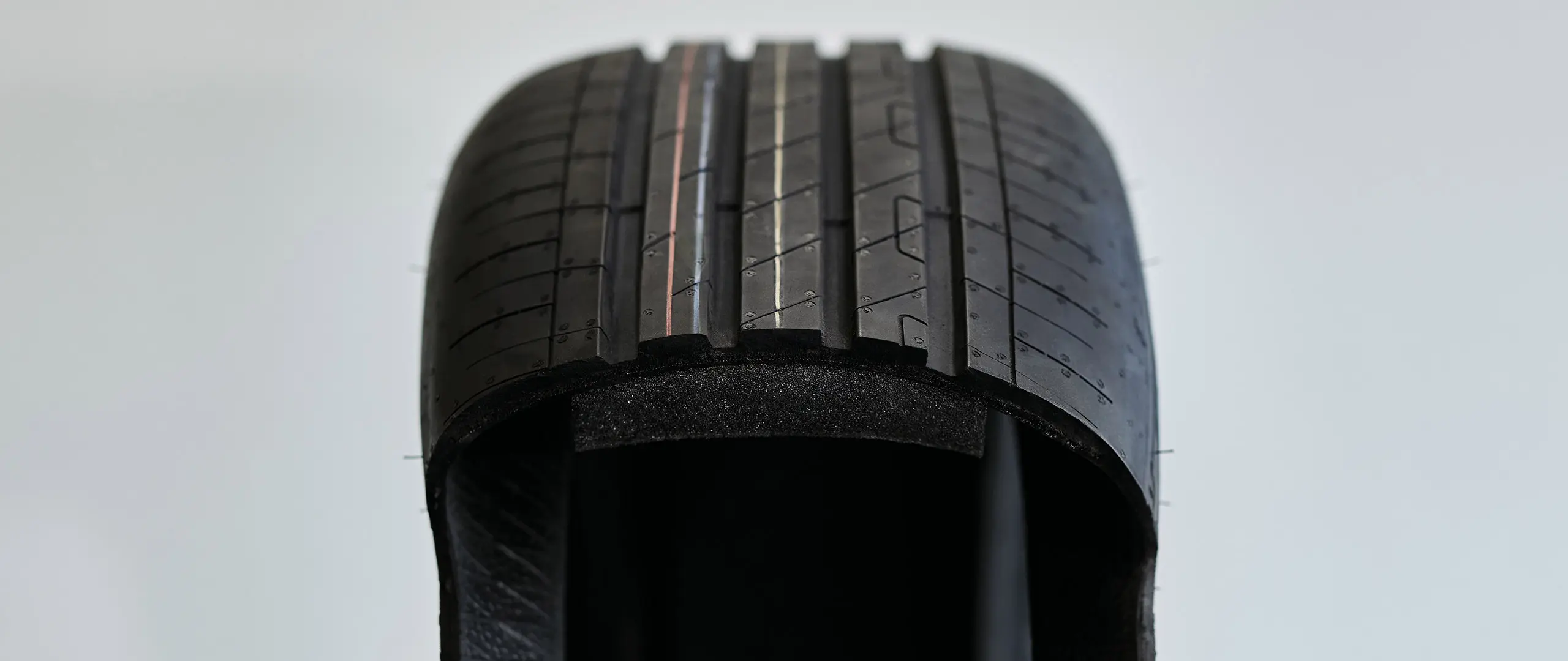 Cutaway view of a run-flat tyre showing the thickened, sturdy sidewall that supports the vehicle weight after a puncture.