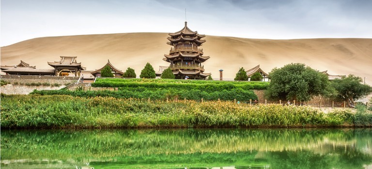 Crescent Lake on the edge of the Taklamakan Desert stands out in vivid contrast to the undulating mountains of sand that surround it – a spectacular desert oasis.