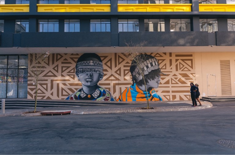 A painted mural, Rooted, by Dbongz at Jewel City in Johannesburg.